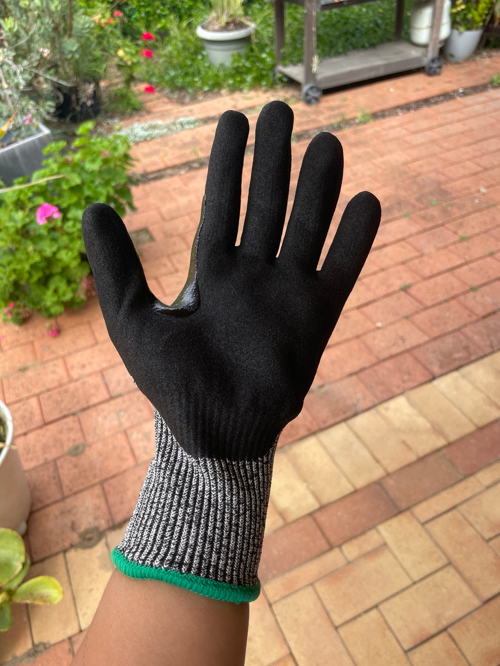 Palm view of a SiteGrips work glove showing its black grip coating.