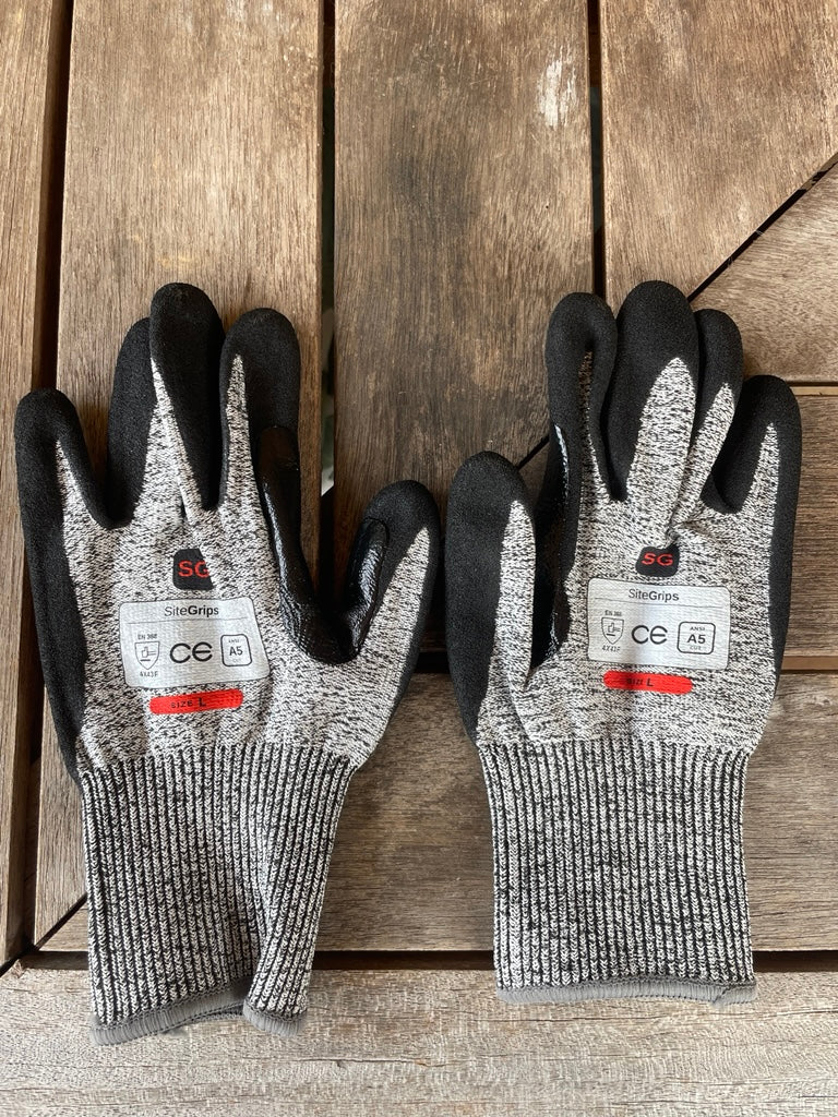 Pair of SiteGrips cut-resistant gloves shown side by side with their safety labels.