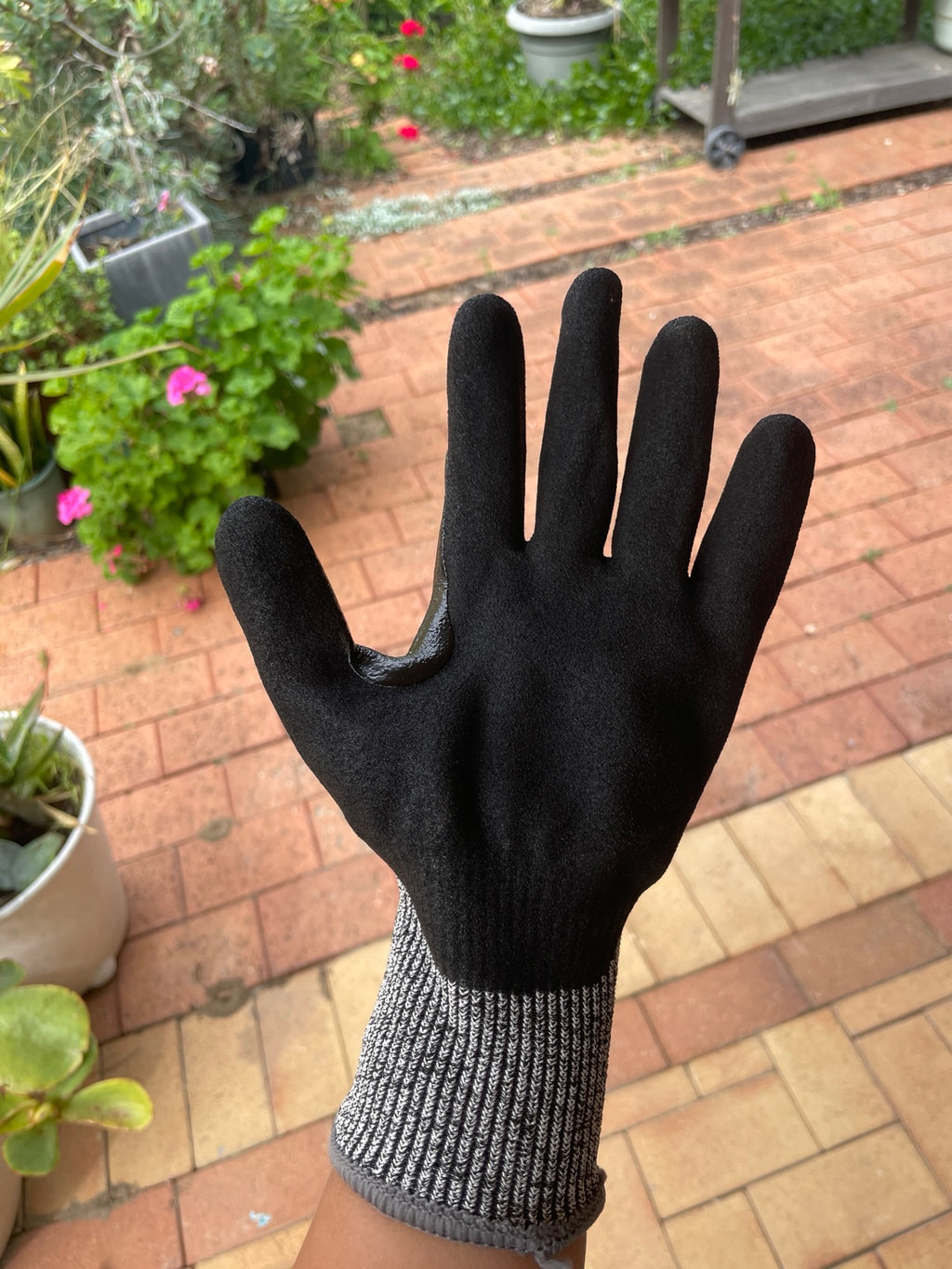 Palm view of a SiteGrips work glove showing its black grip coating and fingers.