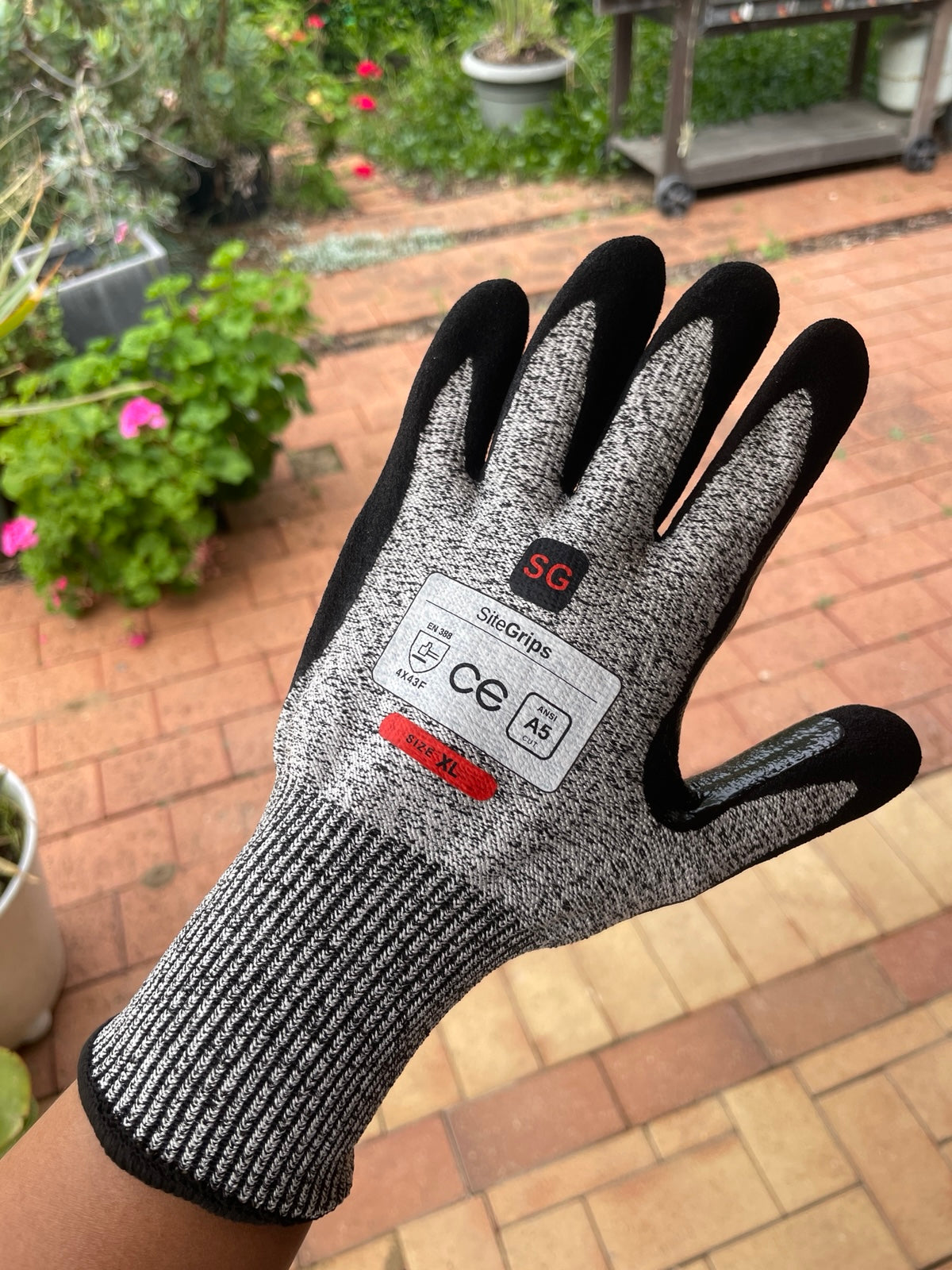 Close view of a SiteGrips work glove showing the woven shell and label.