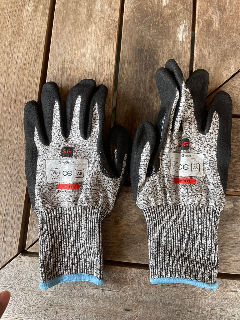 Pair of SiteGrips gloves with blue and green cuffs shown side by side.